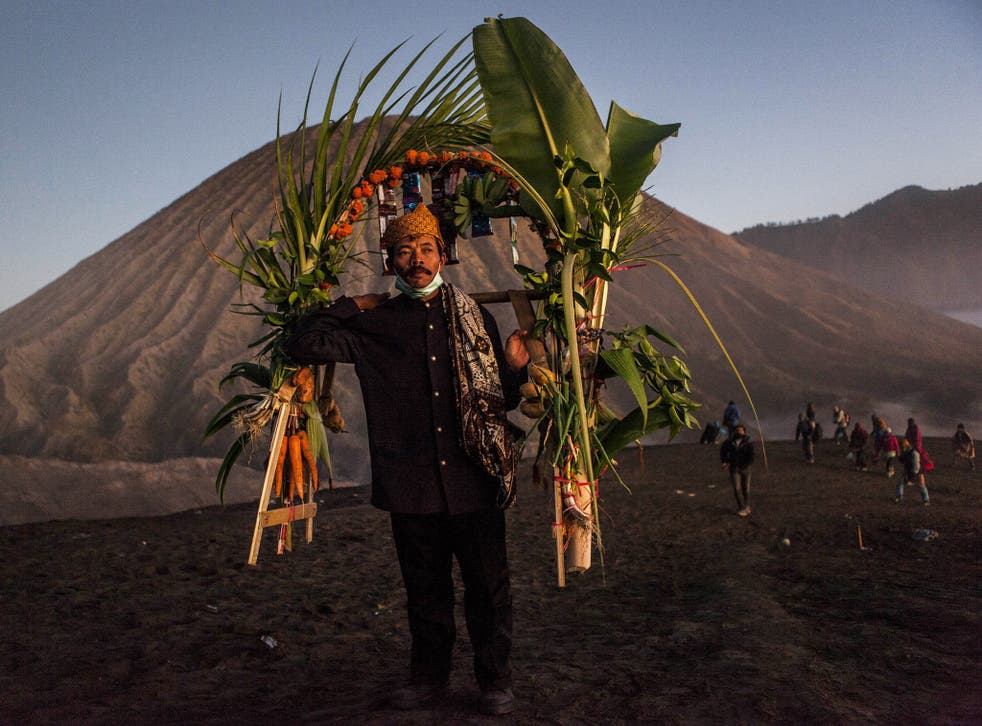 A Tenggerese worshipper carries vegetables for an offerings during the Yadnya Kasada Festival at crater of Mount Bromo in Probolinggo, East Java 