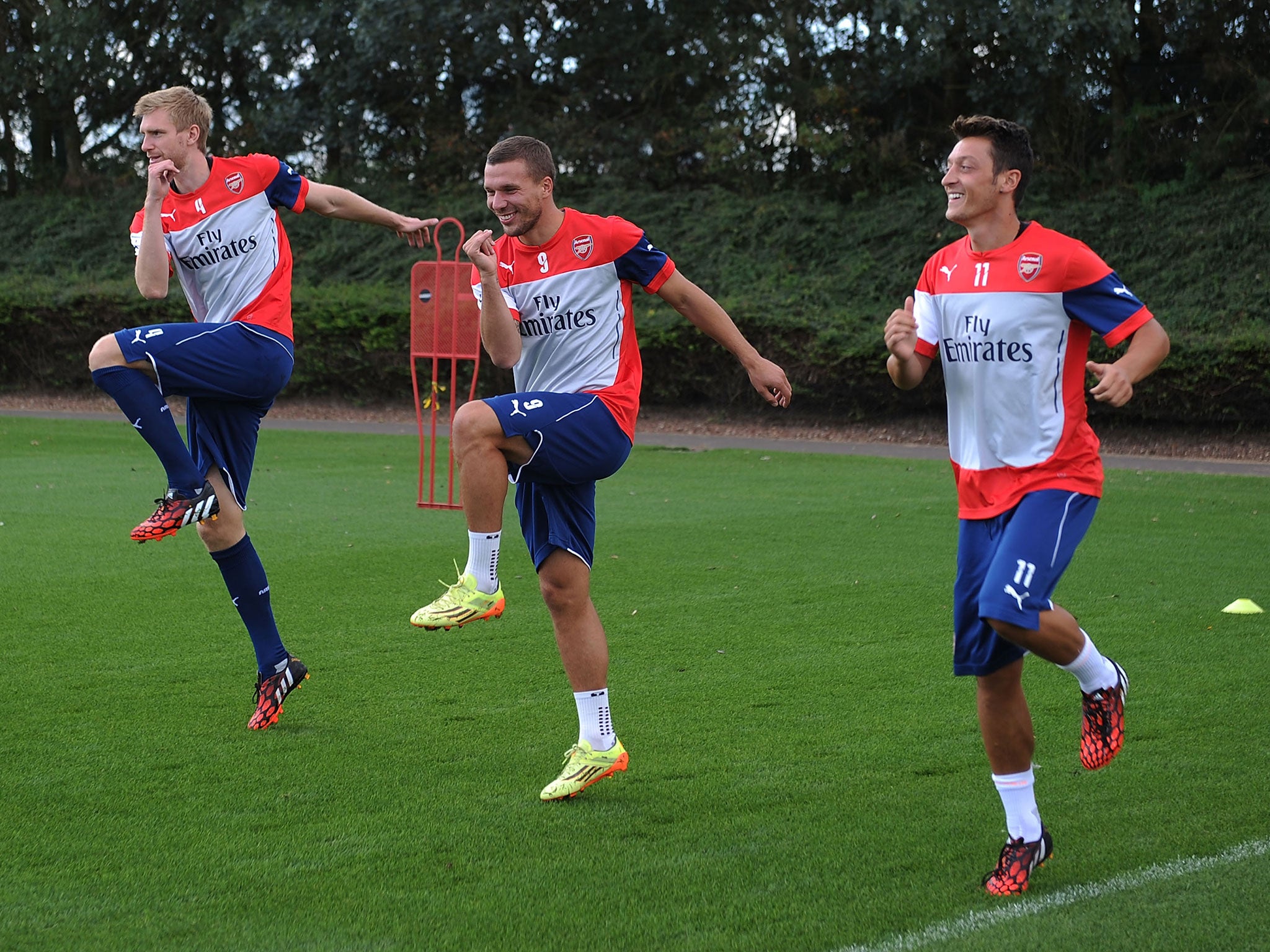 Per Mertesacker, Lukas Podolski and Mesut Ozil during Arsenal training
