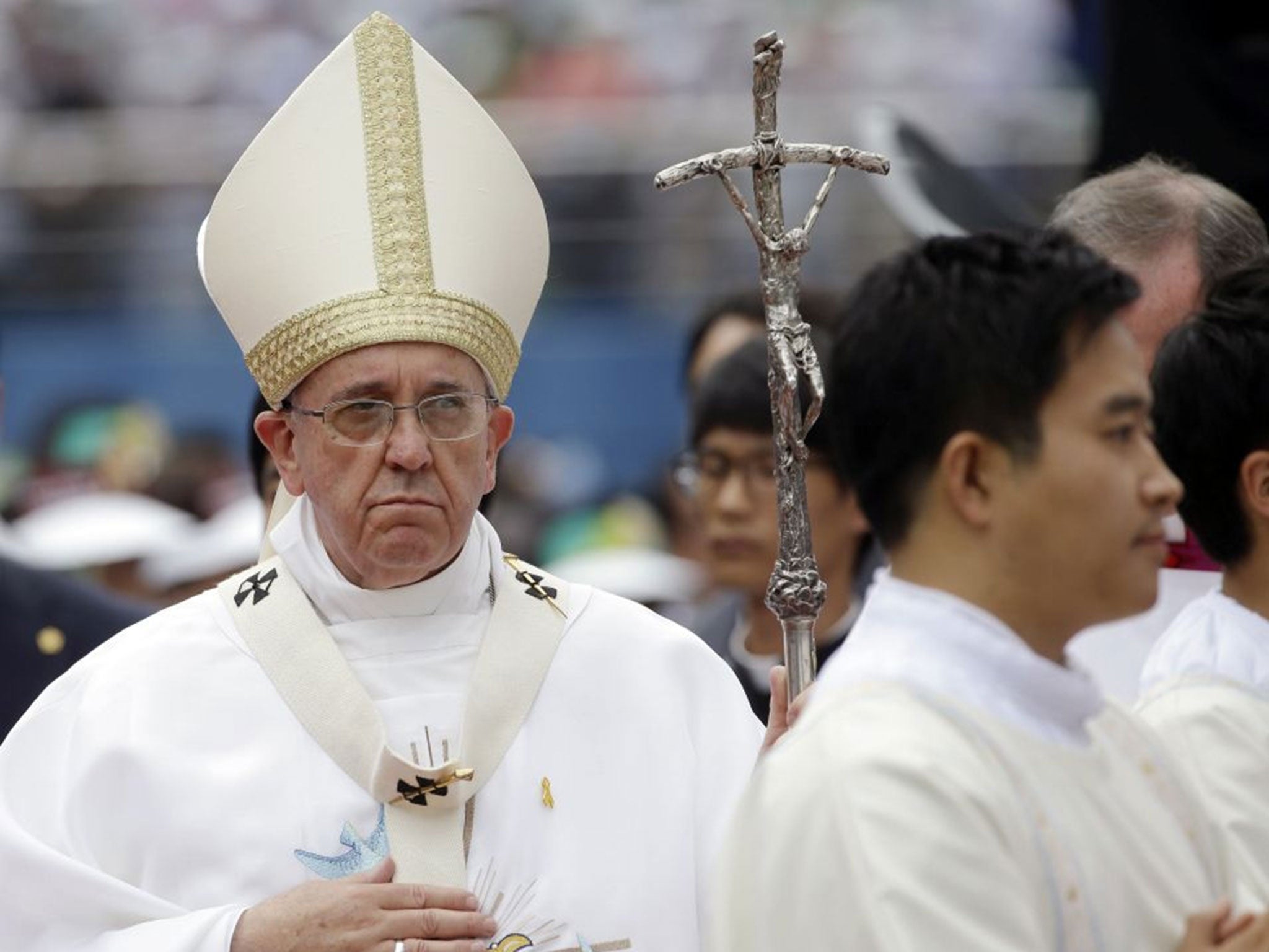 Pope Francis walks with his pastoral staff as he arrives to celebrate a mass in Daejeon's stadium, South Korea, Friday, Aug. 15, 2014.