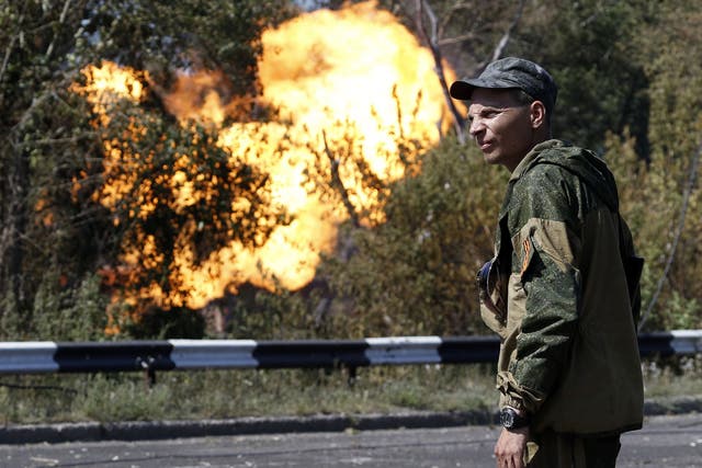 An armed pro-Russian separatist by a shelled gas pipeline in Donetsk yesterday