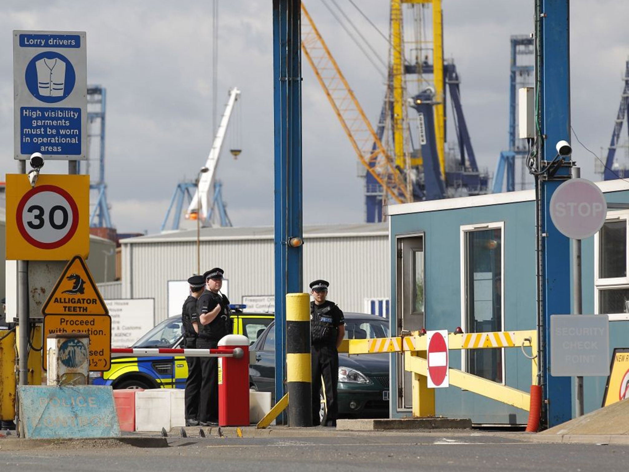 Policemen stand guard at an entrance to Tilbury Docks last August