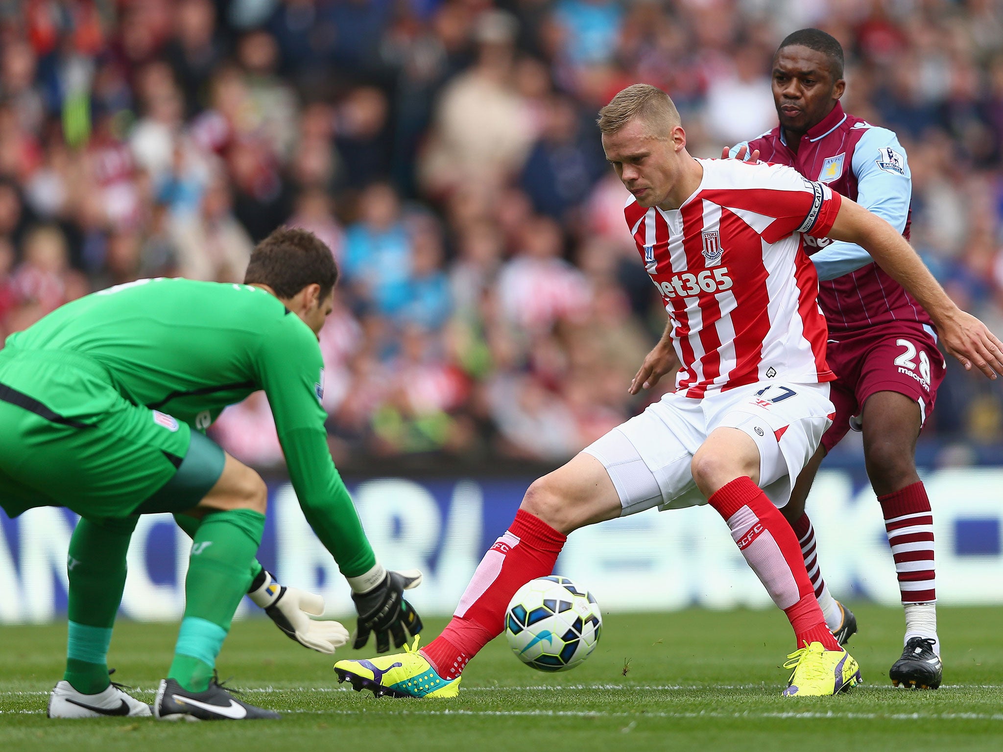Stoke City skipper Ryan Shawcross shields the ball from Charles N'Zogbia, allowing Asmir Begovic to safely collect