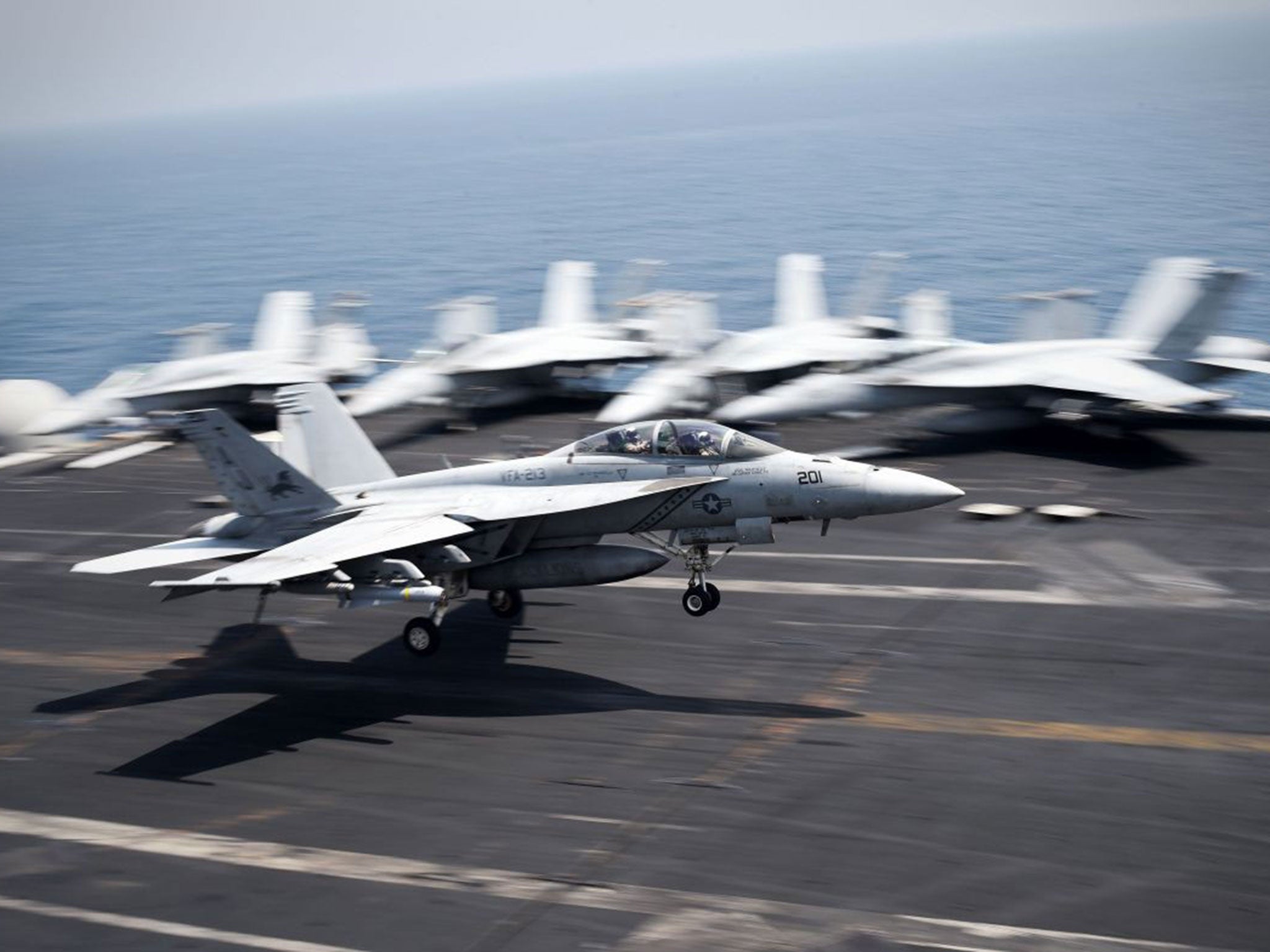 An F/A-18C Hornet coming from Iraq lands on the flight deck of the US navy aircraft carrier USS George H.W. Bush on August 15, 2014 in the Gulf