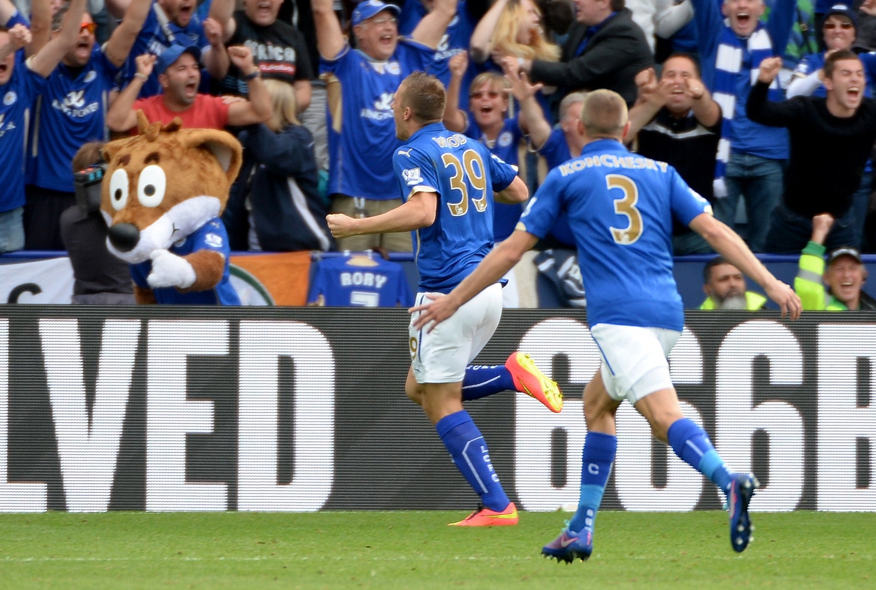 Chris Wood races towards the King Power crowd after grabbing a late winner for the Foxes