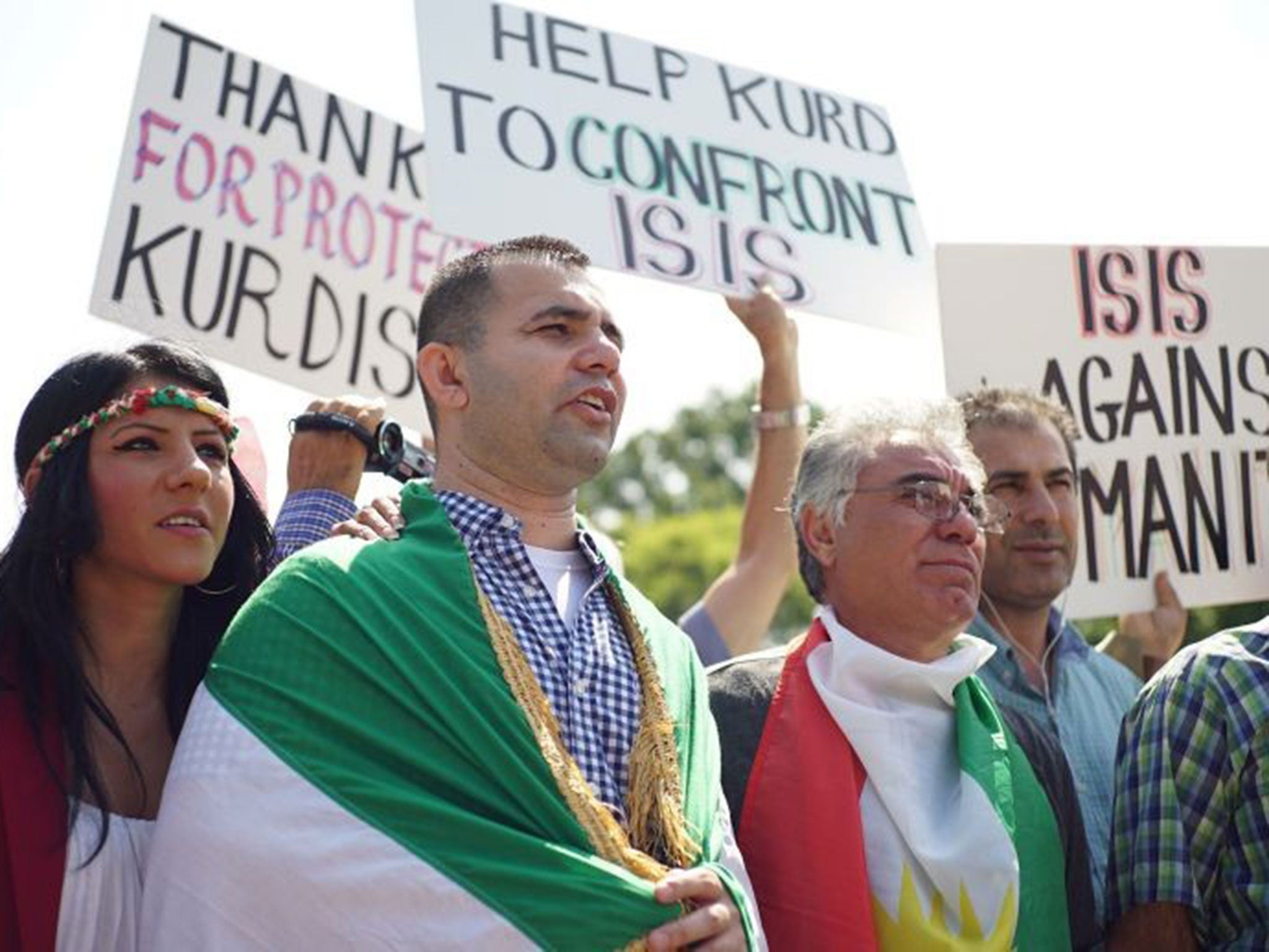 Demonstrators at a rally supporting Kurdistan hold placards protesting against ISIS in front of the White House on August 16, 2014 in Washington, DC.