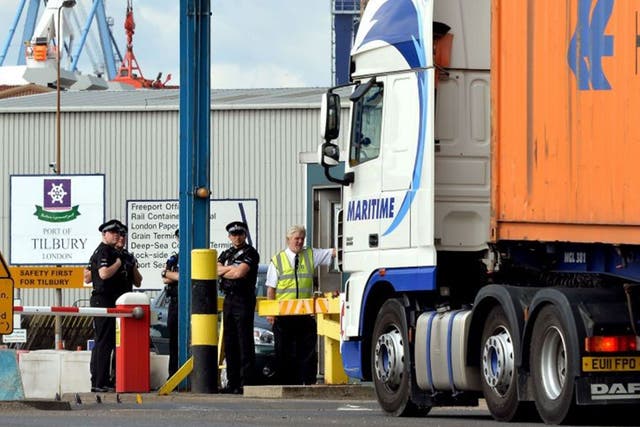 A group of Police Officers stand by the main entrance to Tilbury Docks in Essex, where a shipping container was found with 31 illegal immigrants inside 