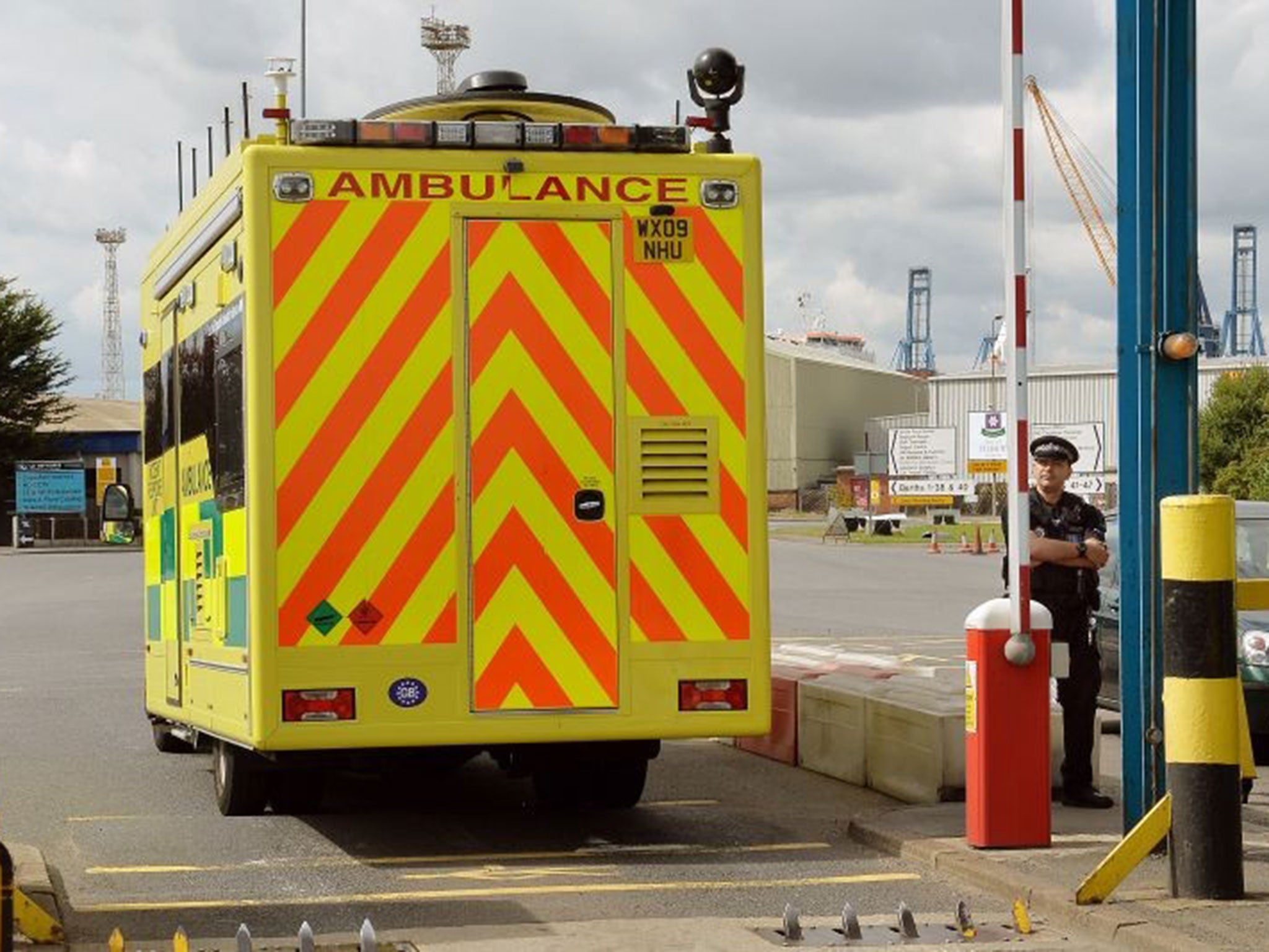 An ambulance incident van passes the main entrance to Tilbury Docks in Essex, where a shipping container was found with 35 people inside