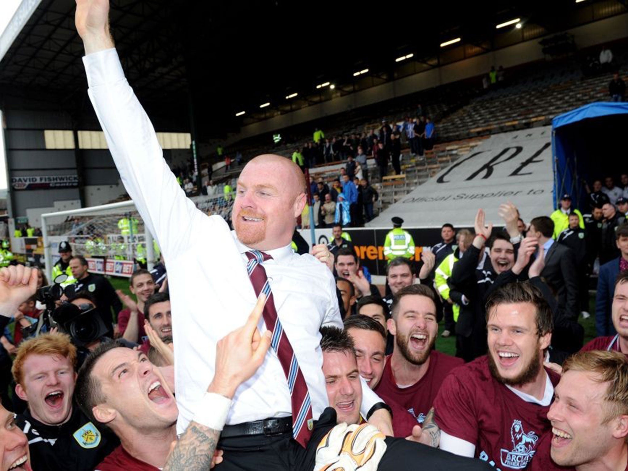 Burnley's manager Sean Dyche celebrates after his side win promotion to the English Premier League during their championship match at Turf Moor, Burnley England