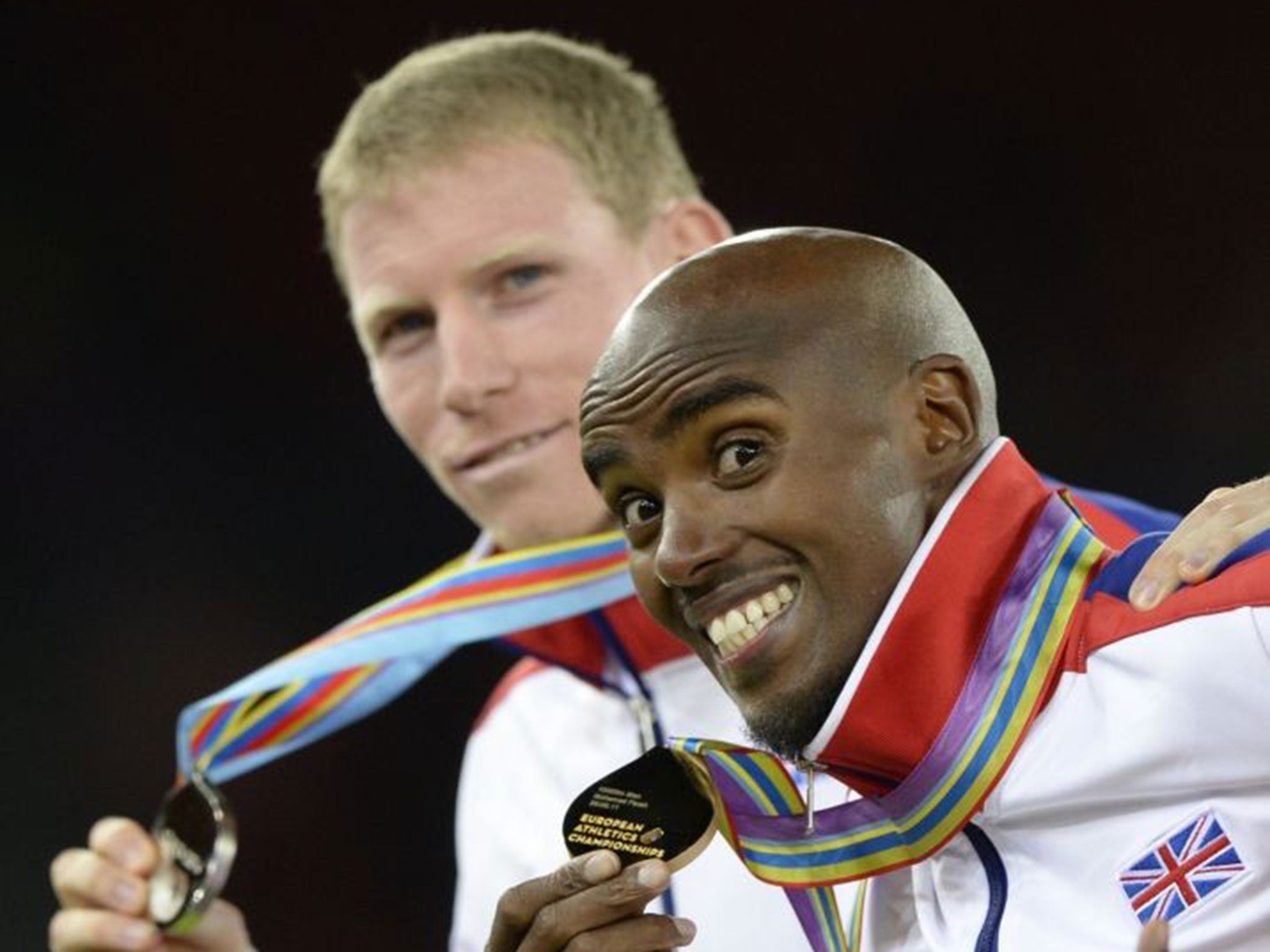 Medal men: Winner Mo Farah and team-mate Andy Vernon, who took silver, celebrate their 10,000m success.