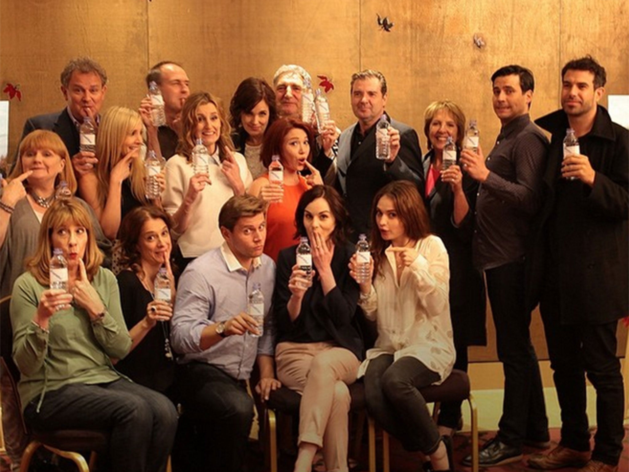 The Downton Abbey cast have made light of the water bottle promo photo gaffe and turned the attention to WaterAid