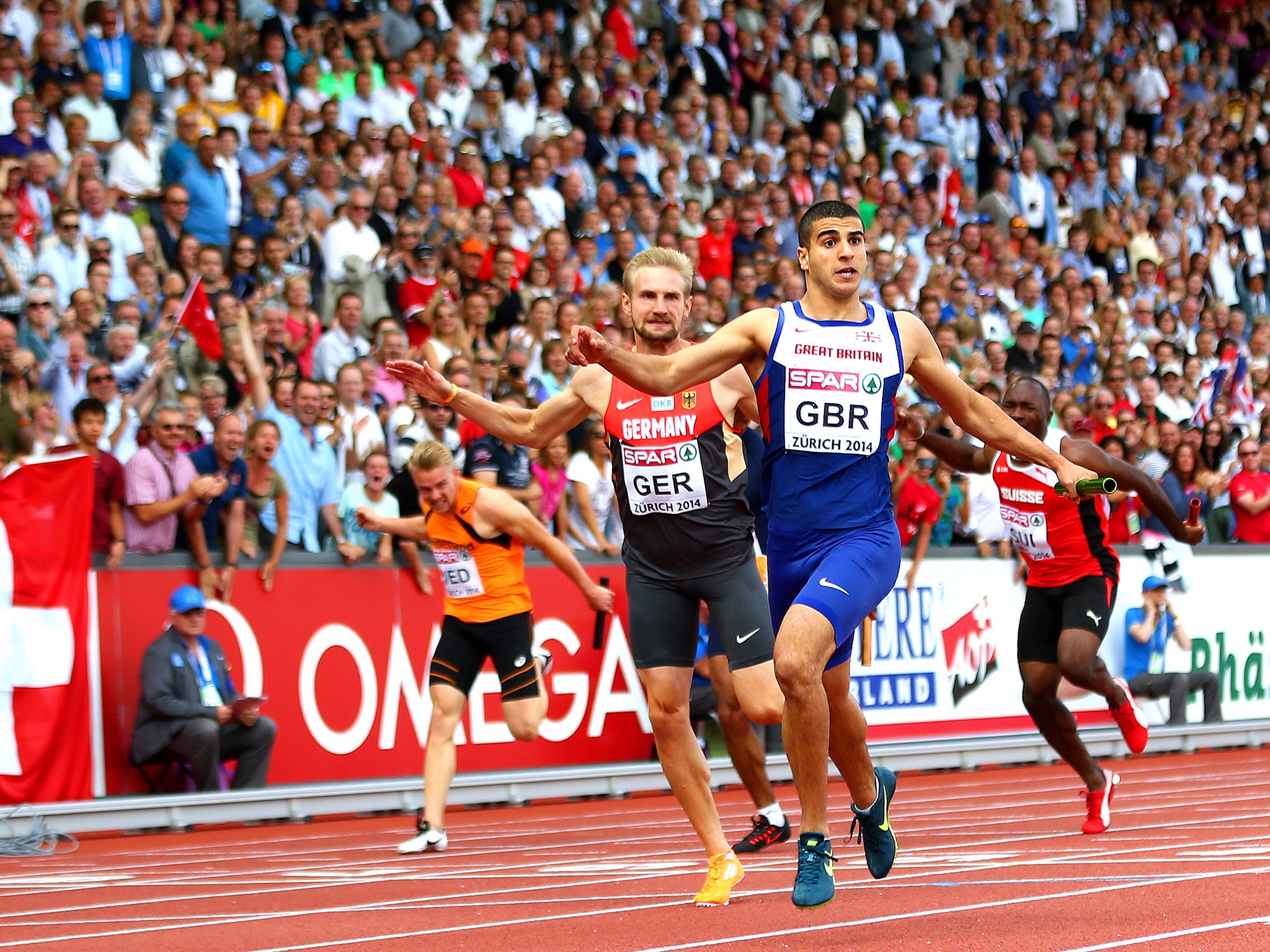 Adam Gemili of Great Britain and Northern Ireland crosses the finish line to win gold in the Men's 4x100 metres relay final