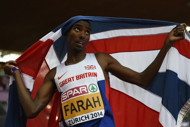 Great Britain's Mohamed Farah, holding his national flag, celebrates after winning the Men's 5000m final 