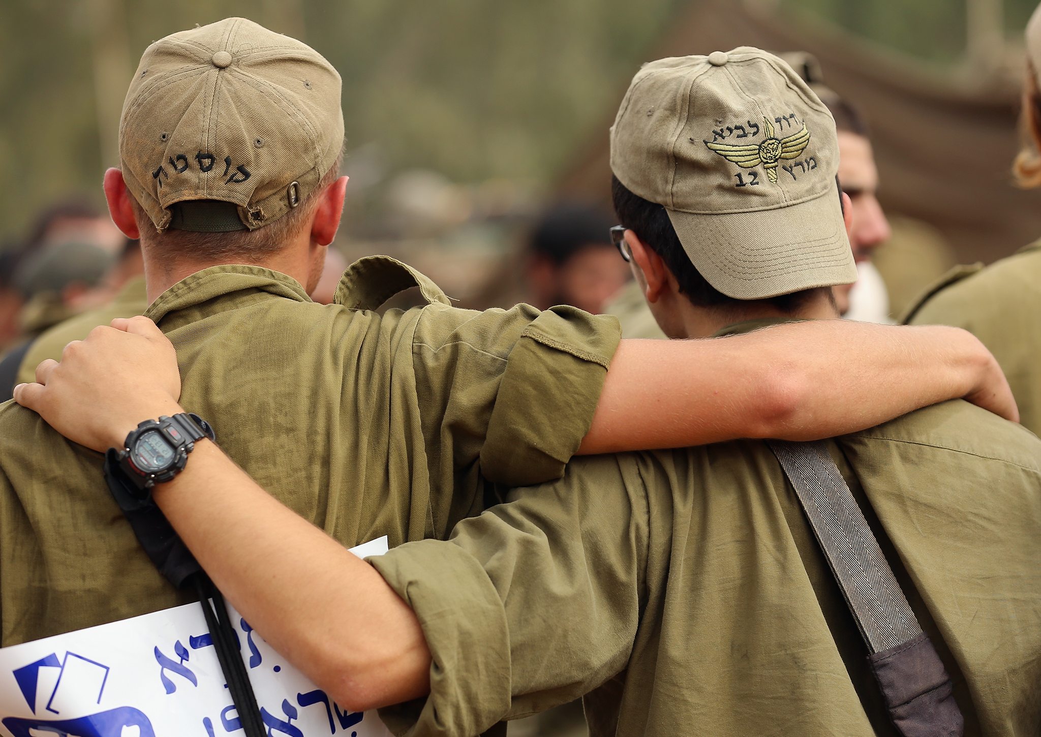 Two IDF soldiers dance to music provided by visiting Hassidic Jews who visited to show their support to soldiers at the border with the Gaza Strip