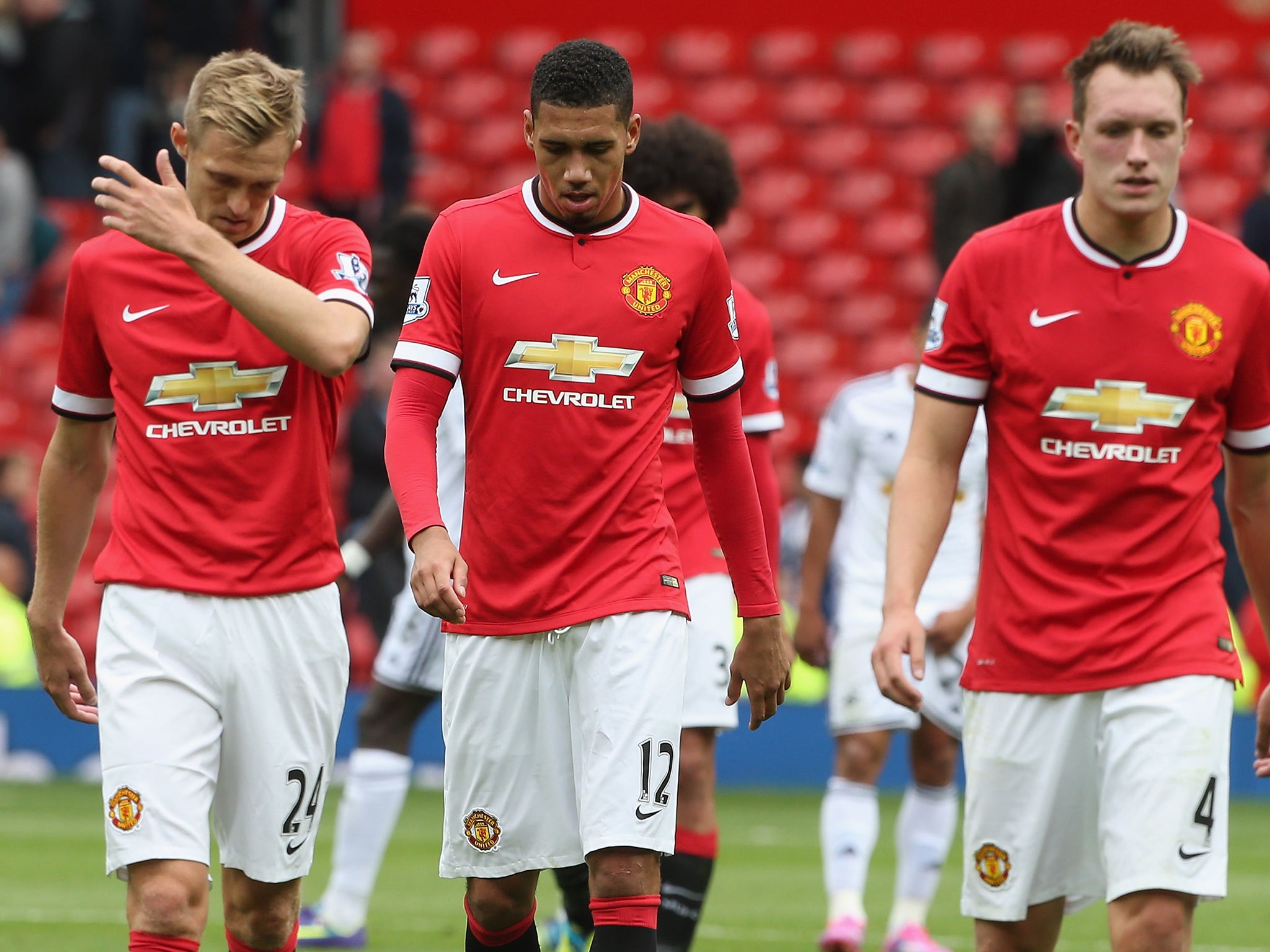 Darren Fletcher, Chris Smalling and Phil Jones leave the pitch after defeat to Swansea