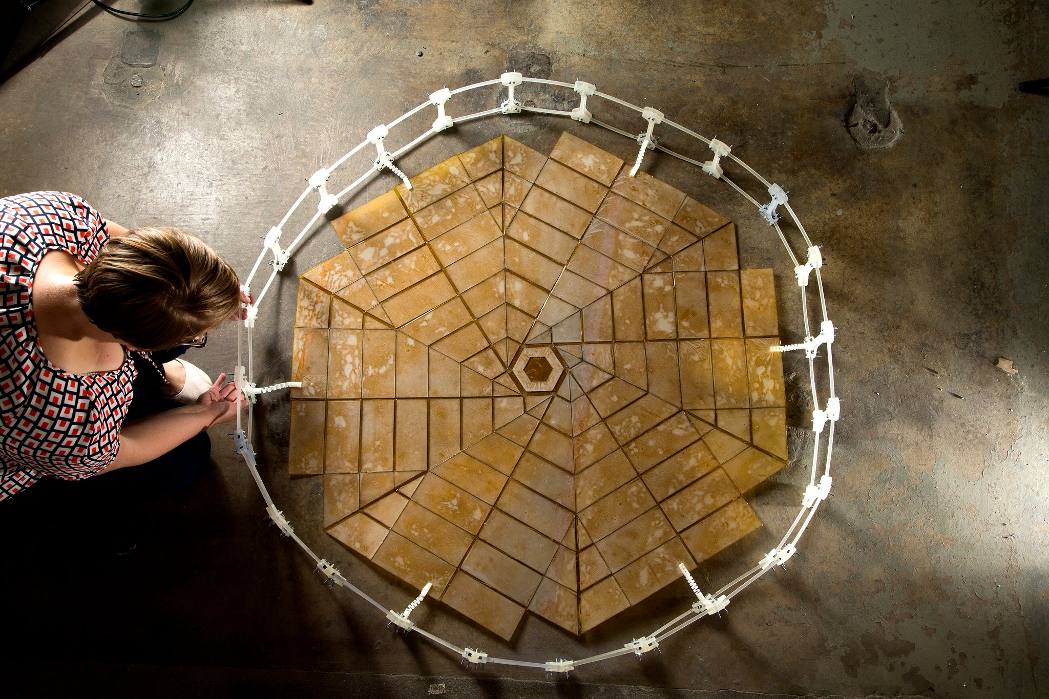 Shannon Zirbel, a Ph.D. student in mechanical engineering at Brigham Young University, Provo, Utah, unfolds a solar panel array that was designed using the principles of origami. She worked on this project with Brian Trease at NASA's Jet Propulsion Laboratory, Pasadena, California.