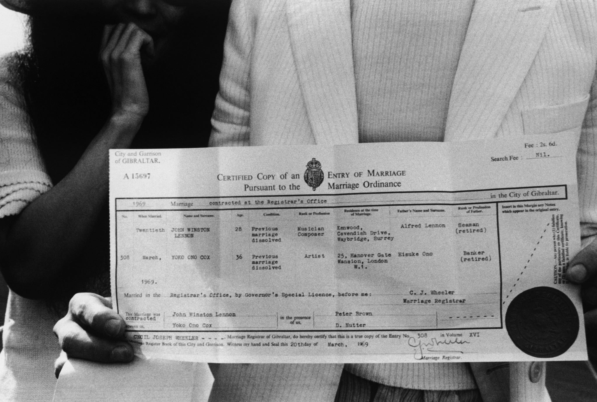 John Lennon and Yoko Ono with their marriage certificate after their wedding on 20th March 1969