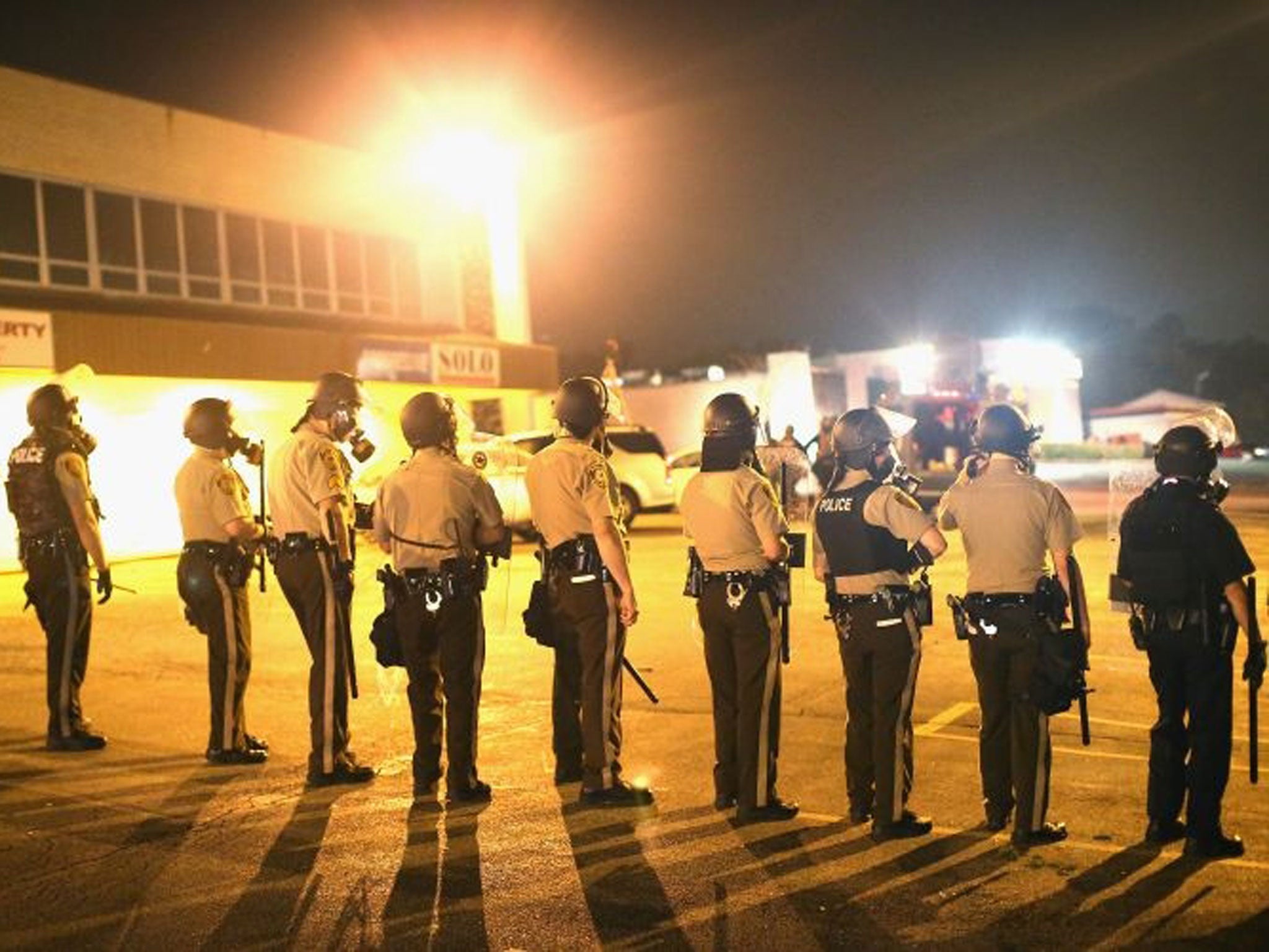 Police advance on demonstrators protesting the killing of teenager Michael Brown on August 17, 2014 in Ferguson, Missouri.