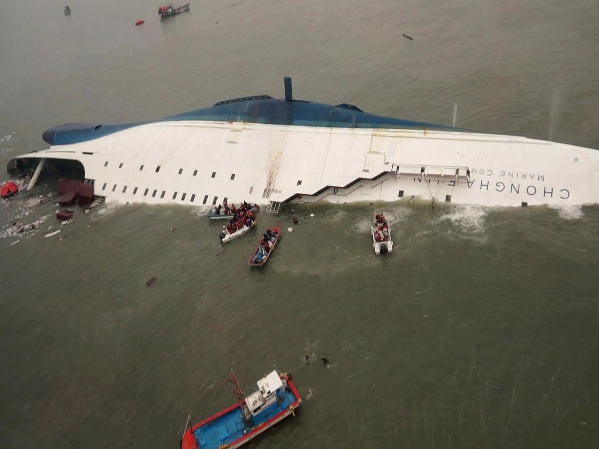 South Korean rescue team boats and fishing boats rescuing passengers off the sinking Sewol ferry in April this year