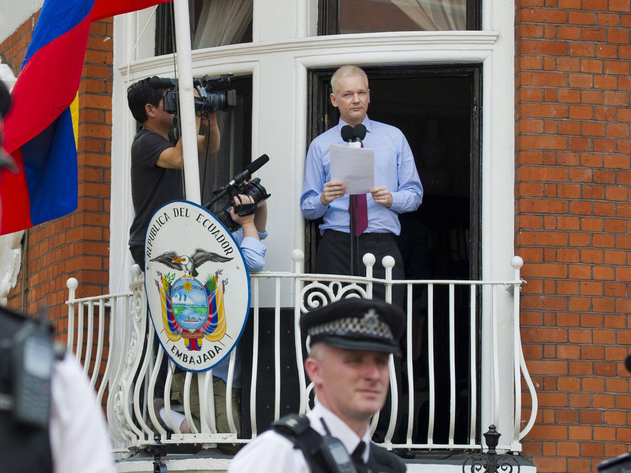 Julian Assange delivering a statement on the balcony at the Ecuador Embassy in 2012 (EPA)
