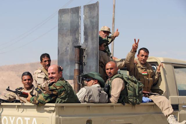 Iraqi Kurdish Peshmerga fighters celebrate recapturing the Mosul dam from Islamic State jihadists