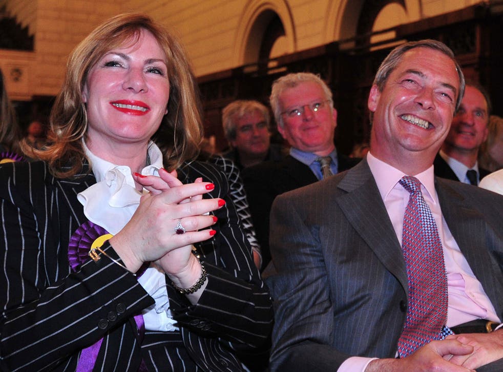 UK Independence Party (UKIP) leader Nigel Farage smiles sitting with UKIP MEP Janice Atkinson as the South East England region results of the European Parliament elections are declared on May 25, 2014