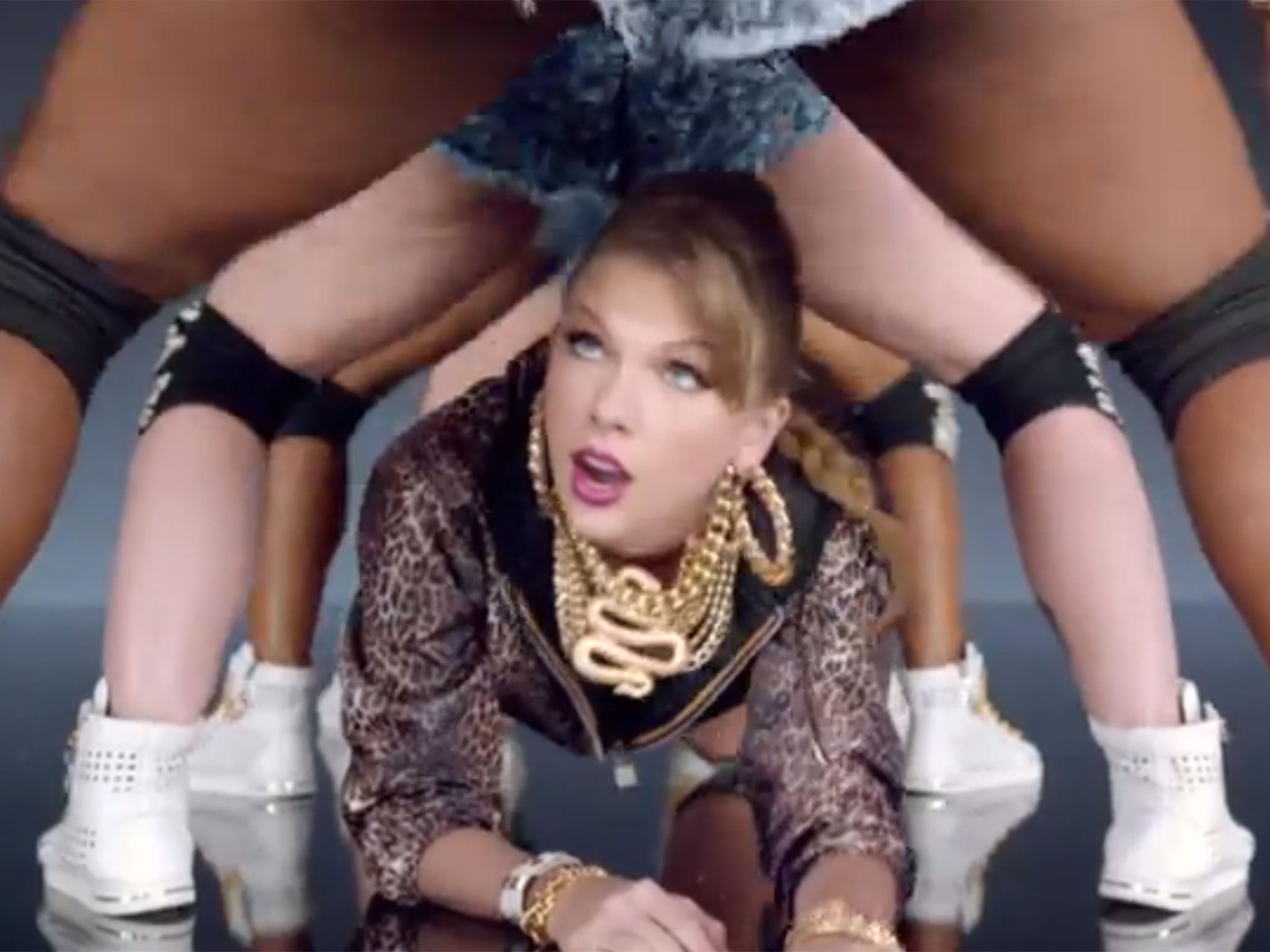 Taylor Swift crawls through the legs of twerking dancers in her 'Shake It Off' music video