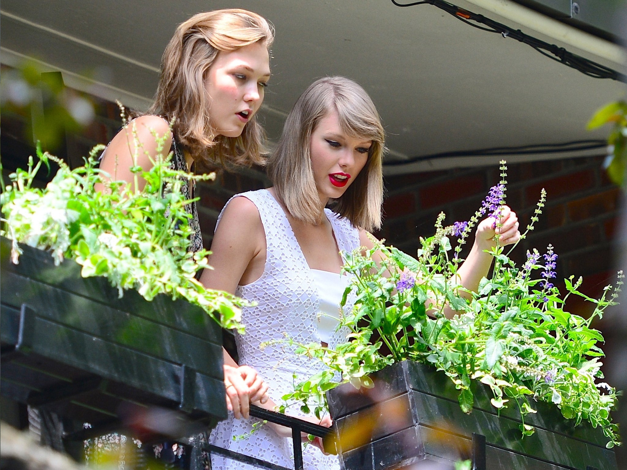 Salad days: singer Taylor Swift and model Karlie Kloss tend to their window box