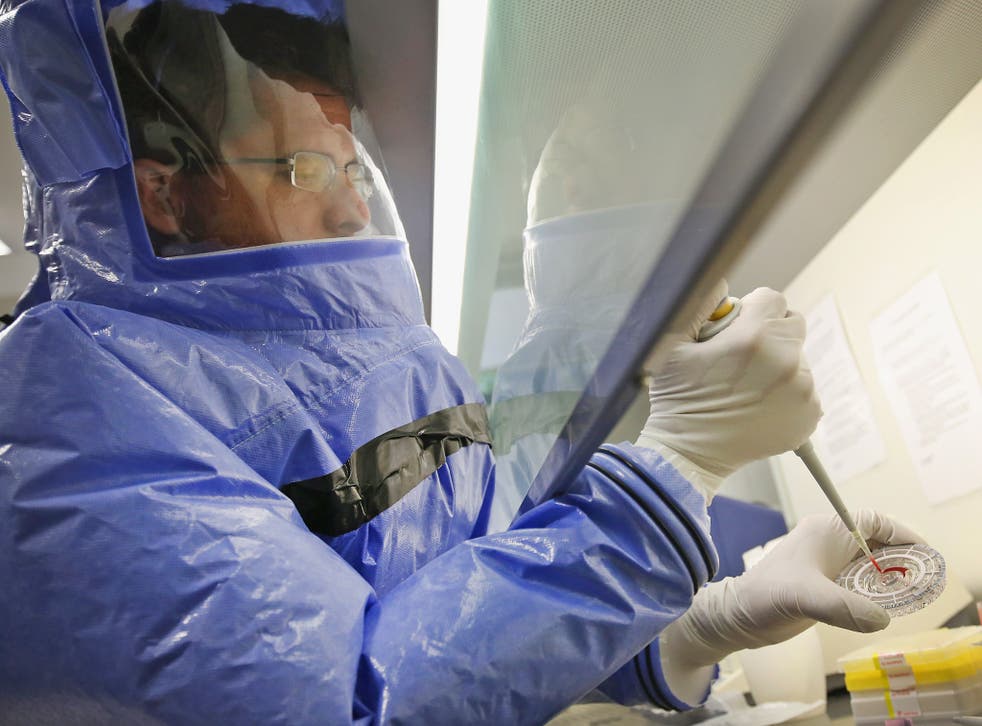 A doctor prepares an Ebola blood sample for analysis