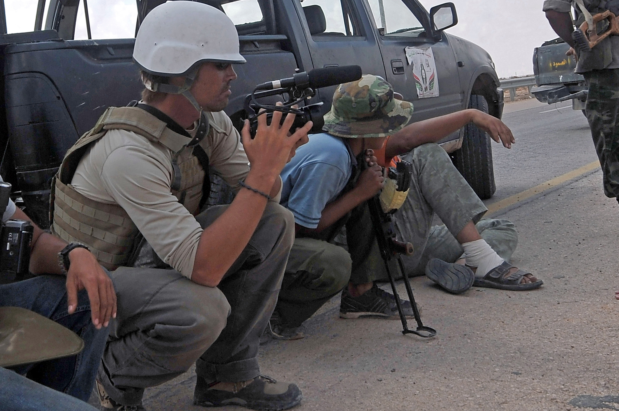 Freelance photo-journalist James Foley (left) on the highway between the airport and the West Gate of Sirte, Libya