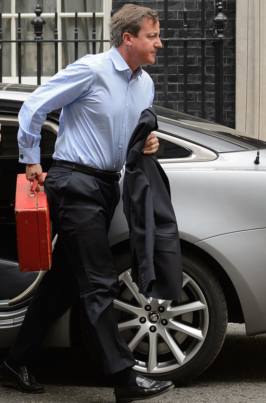 British Prime Minister David Cameron arrives back in Downing Street yesterday after breaking off his holiday early for talks on the threat posed by Islamic State jihadists following the 'shocking and depraved' apparent beheading of US journalist James Fol