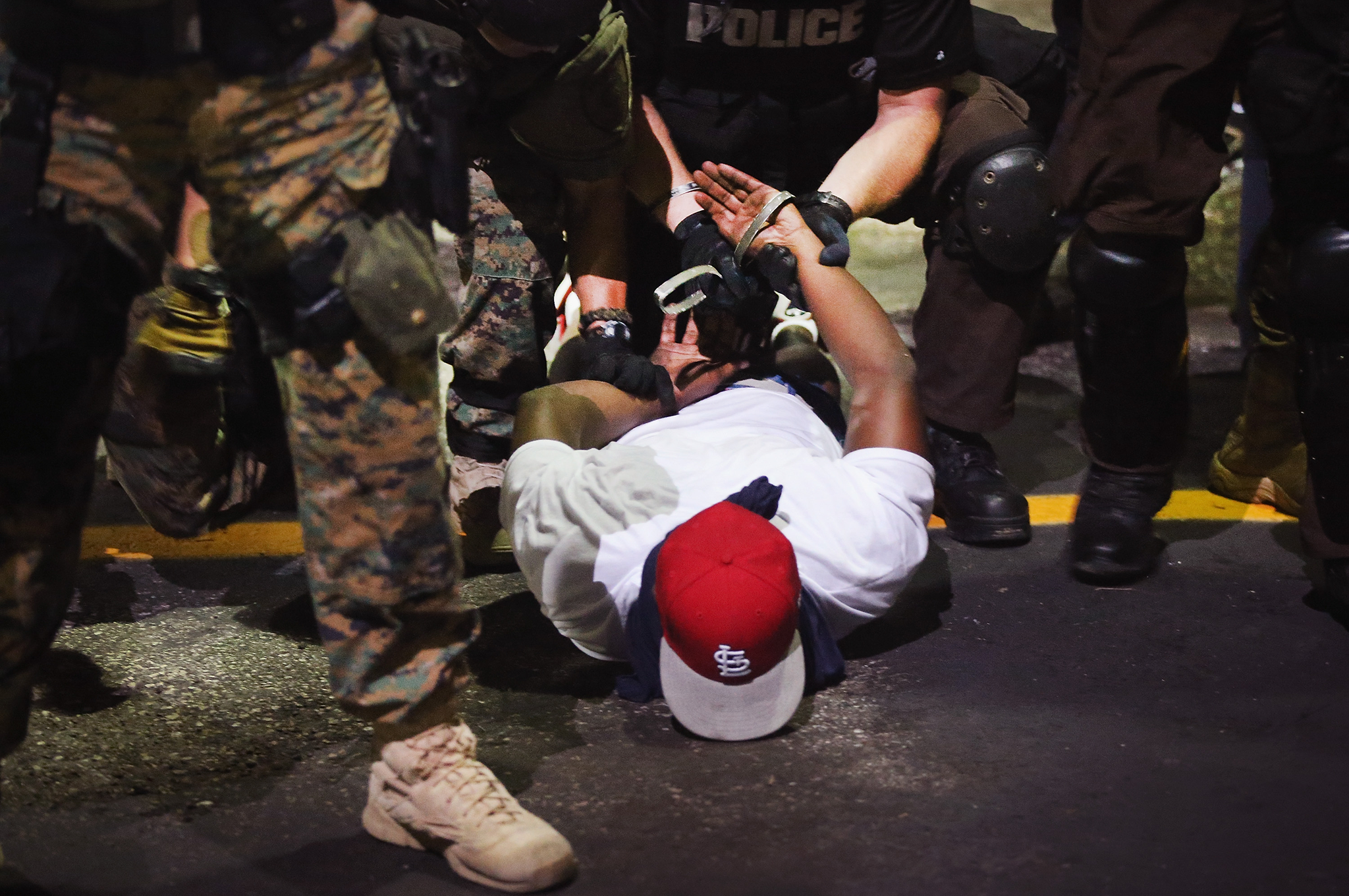 Police arrest a demonstrator protesting the killing of teenager Michael Brown in Ferguson, Missouri