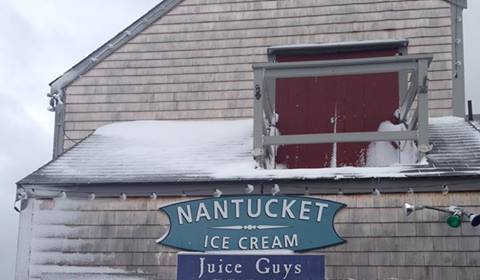 Griffin climbed the Juice Guys building in Nantucket before jumping off the wharf (Picture: Facebook)
