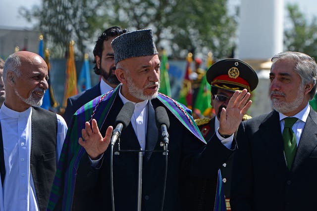 Hamid Karzai (centre) has agreed to step down as Ashraf Ghani
(left) and Abdullah Abdullah (right) fight to succeed him