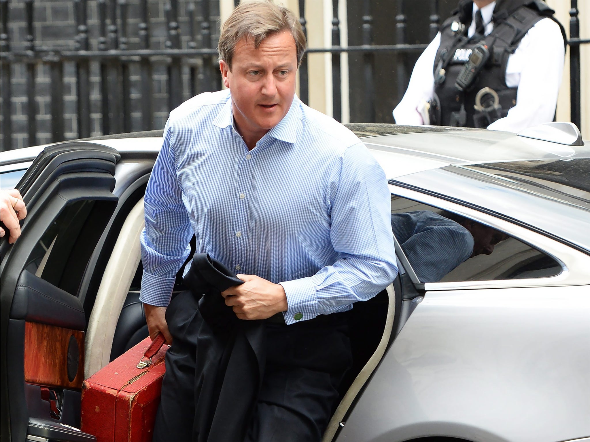 David Cameron arrives at  No 10 yesterday, after cutting short his holiday in Cornwall to hold a national security meeting on Iraq