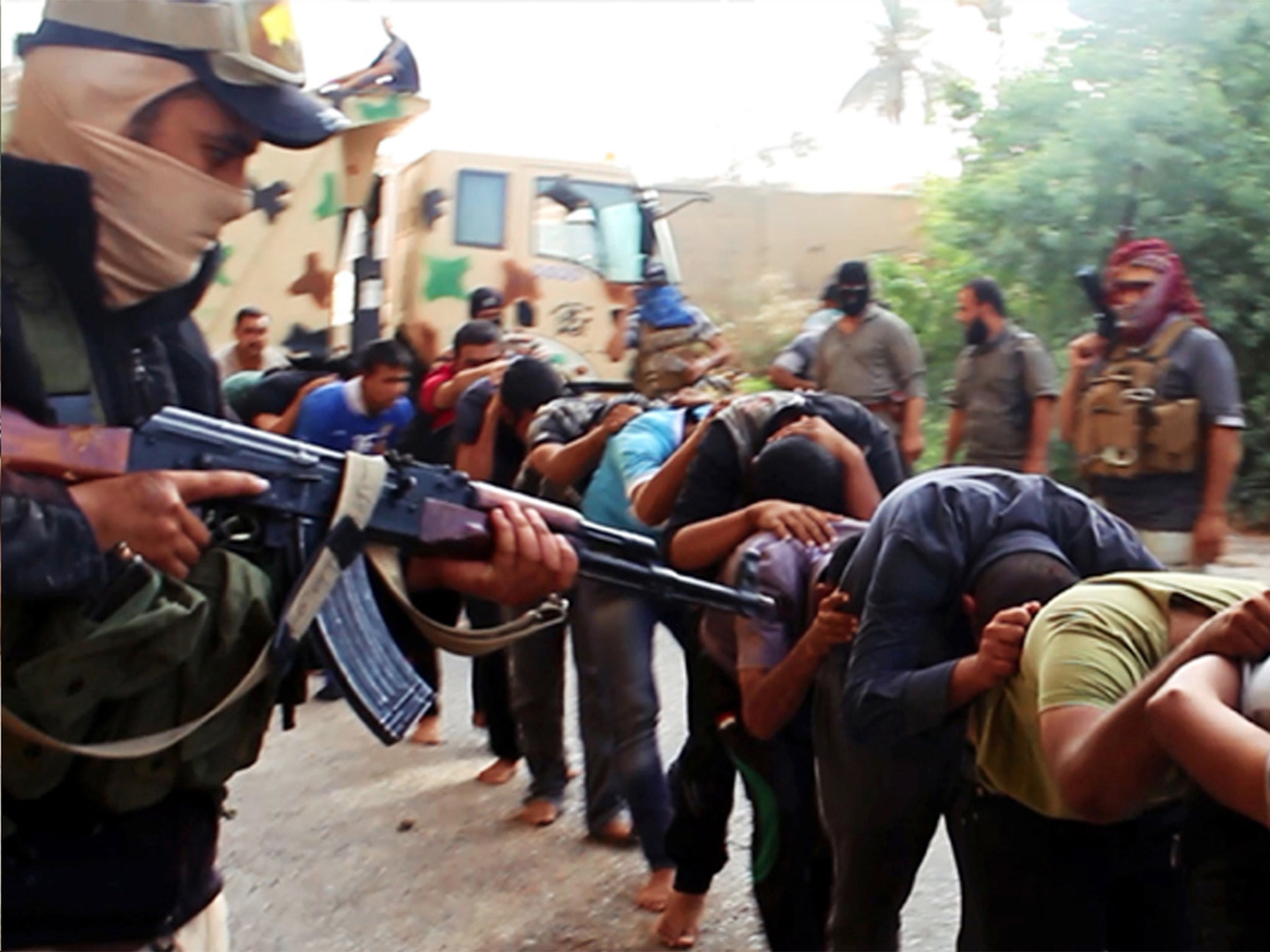 Jihadist militants leading away captured Iraqi soldiers in Tikrit, Iraq, in June