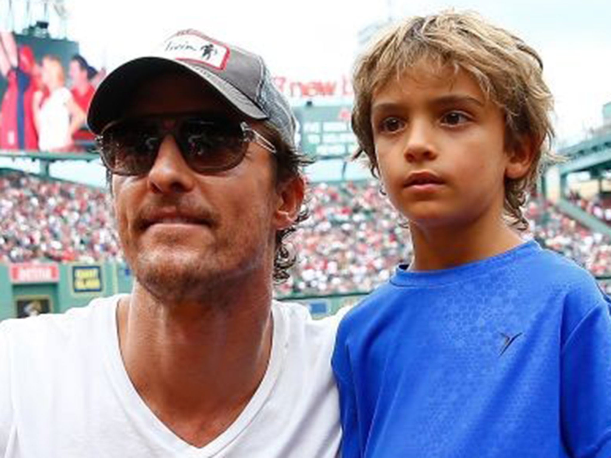 Matthew McConaughey and his son Levi at the game between the Boston Red Sox and the Houston Astros at Fenway Park on August 17, 2014 in Boston, Massachusetts.