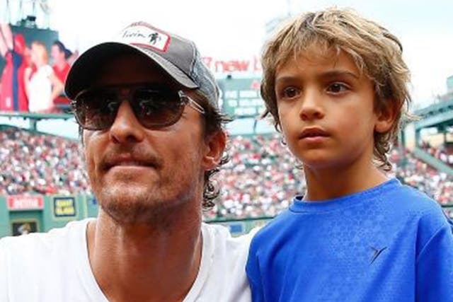 Matthew McConaughey and his son Levi at the game between the Boston Red Sox and the Houston Astros at Fenway Park on August 17, 2014 in Boston, Massachusetts.  