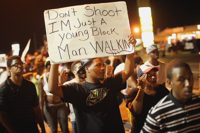 Demonstrators protest the killing of teenager Michael Brown on August 19, 2014 in Ferguson, Missouri. 