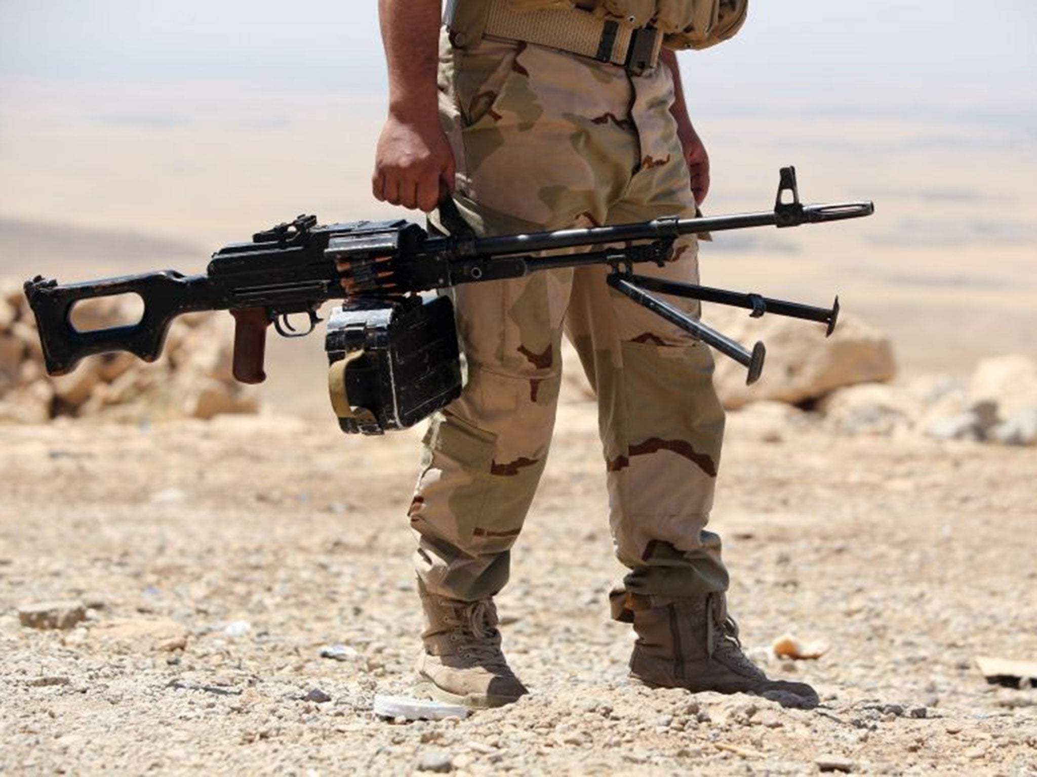 An Iraqi Kurdish Peshmerga fighter taking position on the front line in Mosul, where a church has reportedly been destroyed