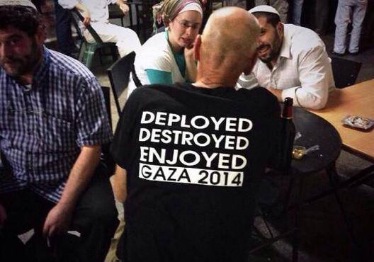 An Israeli man in a Jerusalem bar wears a t shirt celebrating the destruction of Gaza