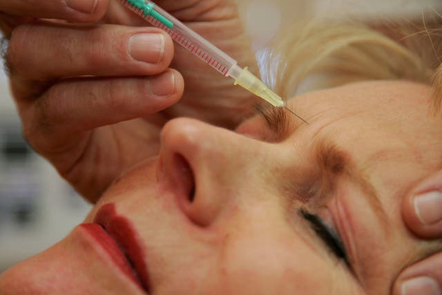 A doctor injects a patient with Botox at a cosmetic treatment centre in Berlin