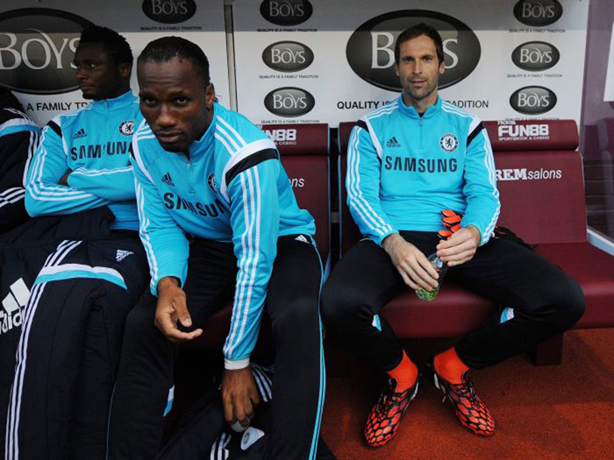 Petr Cech (right) and Chelsea's Didier Drogba (left) sit on the bench before the match between Burnley and Chelsea on Monday