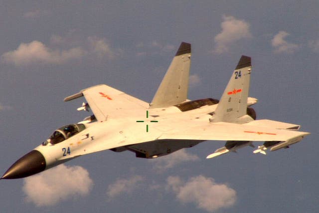 A Chinese fighter jet that the Obama administration said Friday conducted a "dangerous intercept" of a U.S. Navy surveillance and reconnaissance aircraft off the coast of China in international airspace