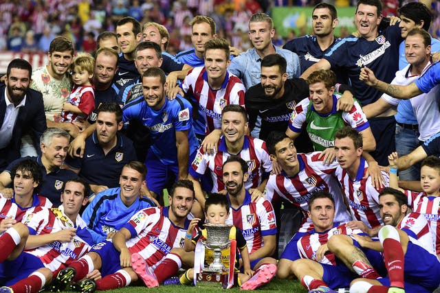 Atletico players celebrate after their victory