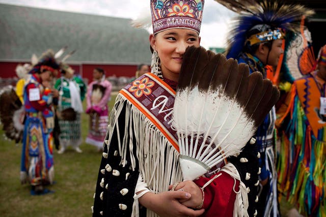 A young Miss Manito Abhee Sage Speidel, 14, from the Lakota nation, wears traditional clothing at an event celebrating National Aboriginal Day in Winnipeg, Manitoba. More than 1 million Canadians are of Aboriginal origin, and the nation has more than 600 