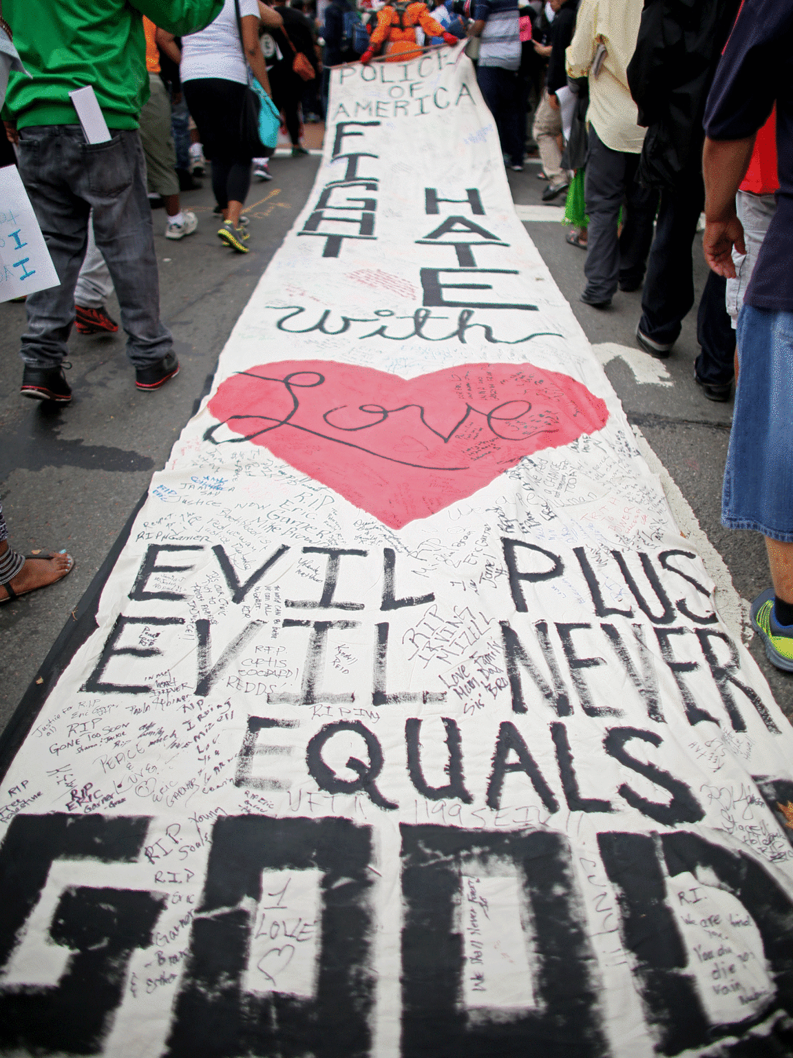 A man carries a large banner through the street as part of Saturday's protest. Source: Getty