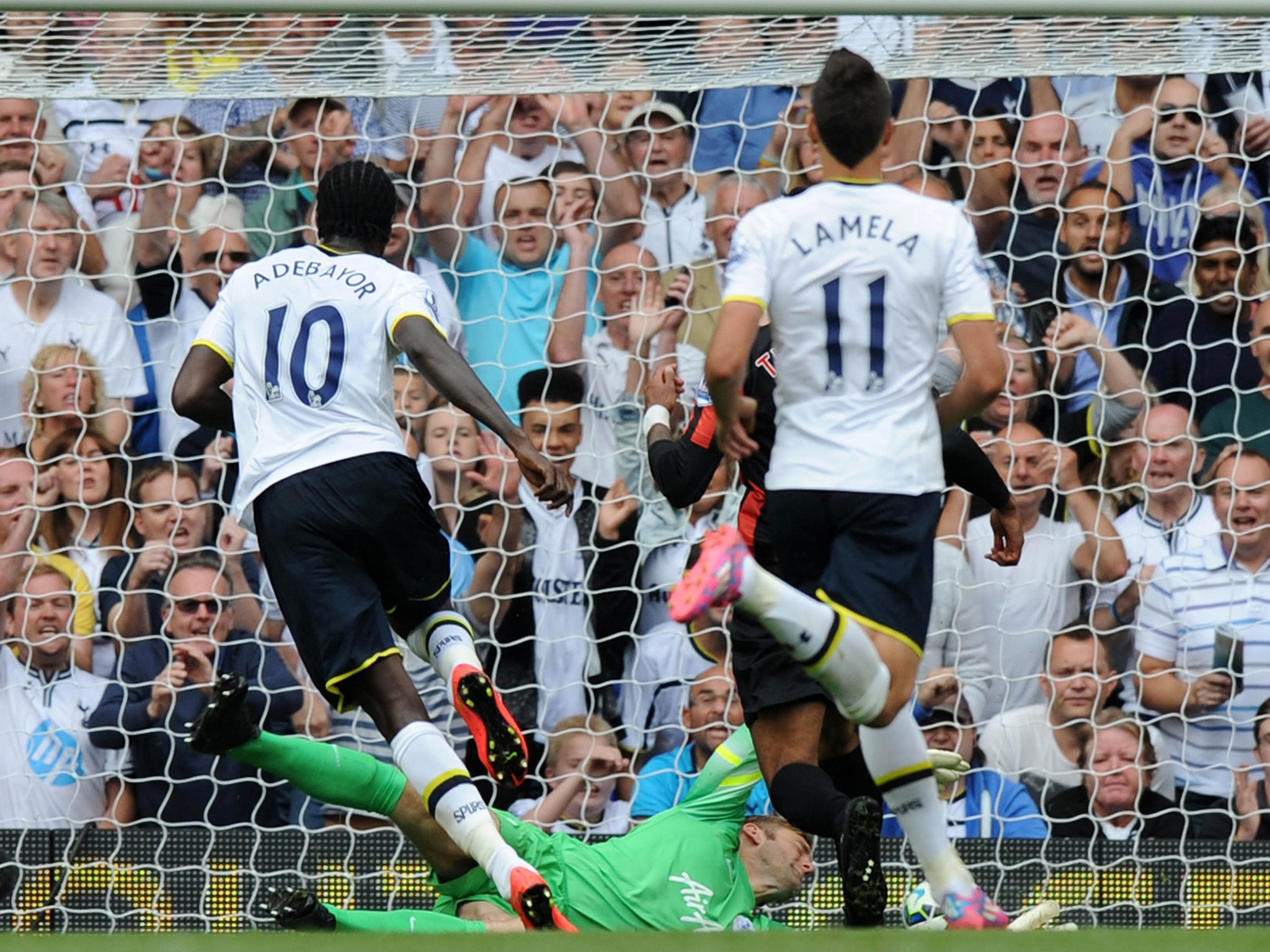 Togolese striker Emmanuel Adebayor (L) scores Tottenham's fourth goal against QPR