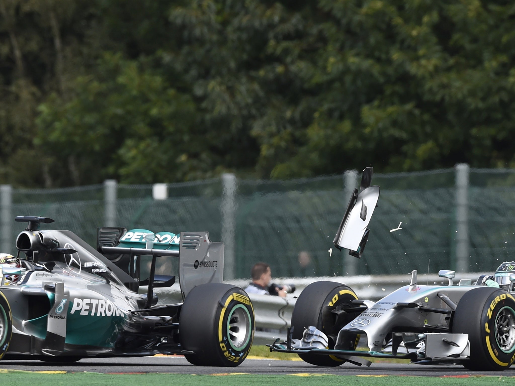 Mercedes-AMG's British driver Lewis Hamilton (L) and and Mercedes-AMG's German driver Nico Rosberg collide at the Spa-Francorchamps ciruit