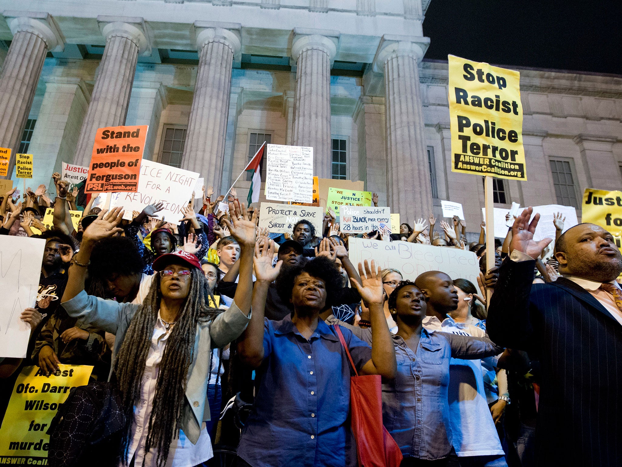 Demonstrators chant at the steps of the National Portrait Gallery in Washington, during a protest against the shooting of unarmed Michael Brown, a black 18-year-old killed by a white police officer in Ferguson