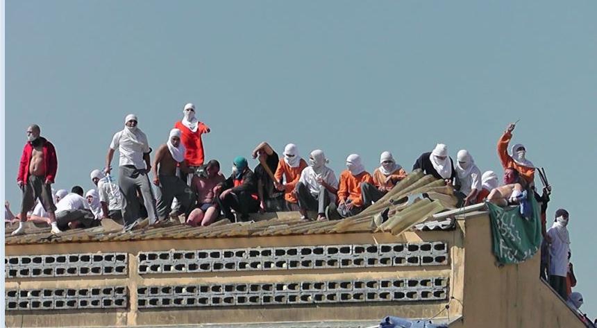 Inmates seen on the roof of a building during the riot